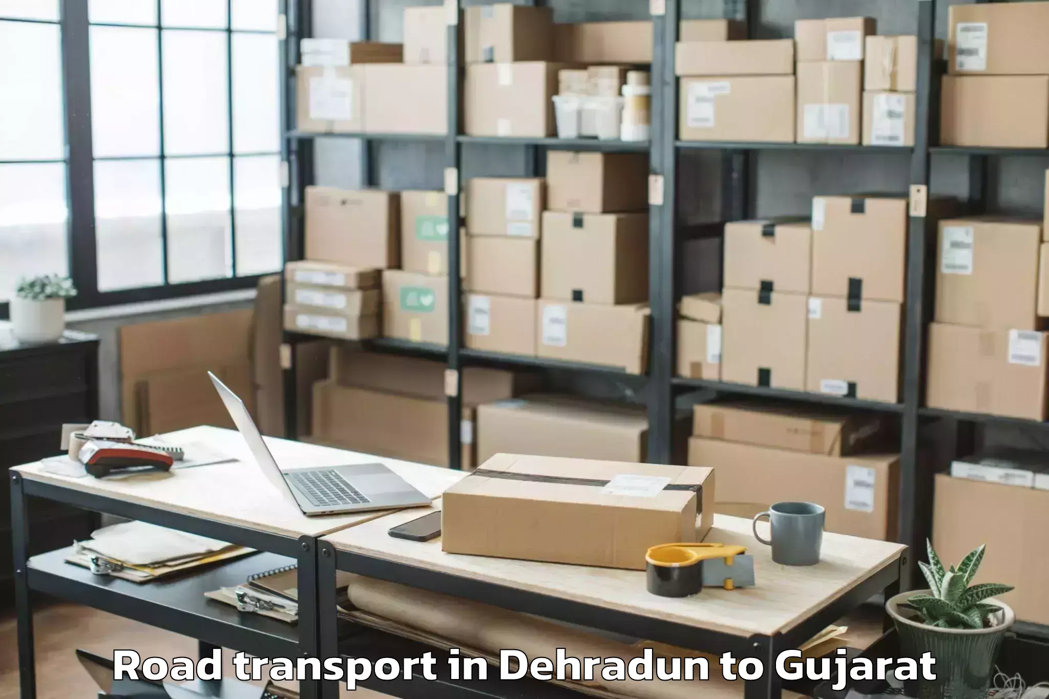 Get Dehradun to Kamdhenu University Gandhinaga Road Transport